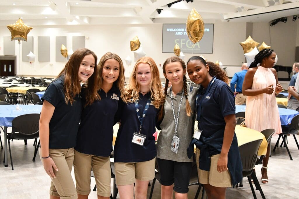 Group of girls in front of tables